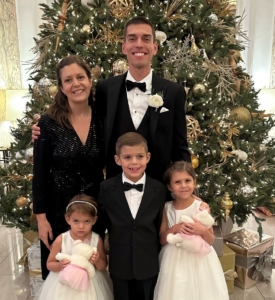 Dr Jacob Ringenberg with wife Carly and three children in front of a Christmas tree